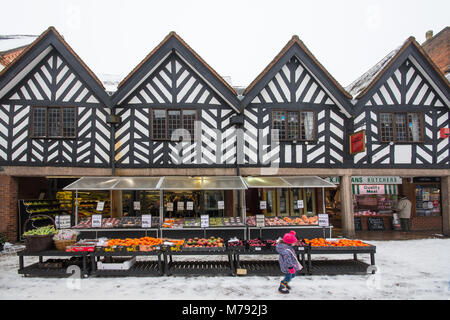 Riley's Greengrocers fruit and vegetable shop on unseasonal snowy day Lichfield Staffordshire England 3rd March 2018 with oranges on display in snow Stock Photo