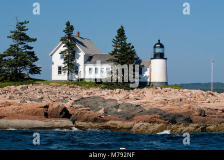 Winter Harbor lighthouse is an island beacon in down east Maine, on a summer day near Acadia National Park. Stock Photo