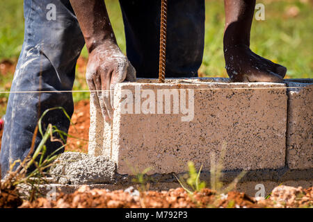 Cement Blocks being laid to build a wall on a Construction Site in the Caribbean. Cement is the primary material used there for construction. Stock Photo