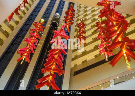 Glass elevators and red decorations for Chinese New Year in the Atrium of the Pan Pacific Marina Bay Hotel, Singapore. Stock Photo