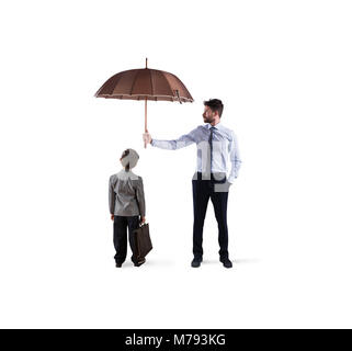 Businessman with umbrella that protect a child. Concept of young economy and startup protection Stock Photo