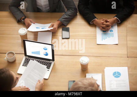 Business team brainstorming analyzing statistics report at meeti Stock Photo