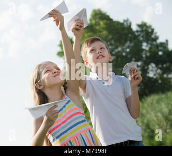 Happy boy and girl flying an American flag Stock Photo - Alamy