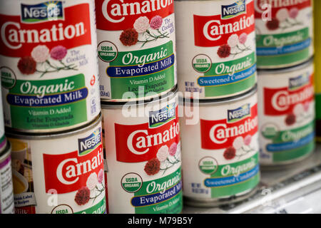 Cans of Nestle Foods products, Carnation Evaporated Milk and Carnation Sweetened Condensed Milk, both organic, are seen on a supermarket shelf in New York on Monday, March 5, 2018. (Â© Richard B. Levine) Stock Photo