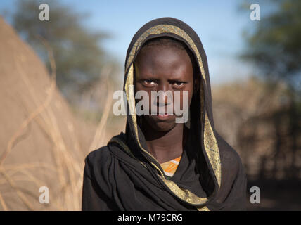 Portrait of an afar tribe teenage girl in front of her hut, Afar region, Afambo, Ethiopia Stock Photo