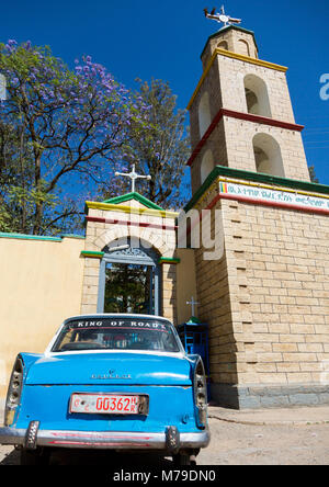 Harari famous peugeot 404 taxi in front of a church, Harari region, Harar, Ethiopia Stock Photo