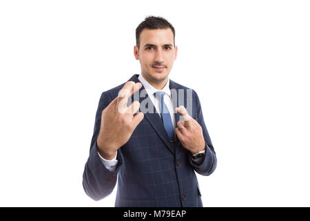 Banker or broker smiling with  fingers crossed isolated on white background as hope wish concept Stock Photo