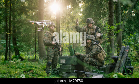 In the Military Staging Base Army Engineer and Soldiers Operate Military Grade Industrial Drone for their Reconnaisance/ Surveillance Mission. Stock Photo