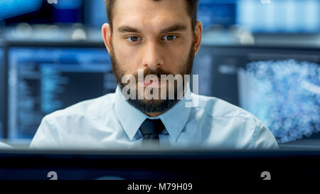 Neural Network and Machine Learning Engineer Working Hard at His Workstation. Multiple Displays Show Neural Network Representation. Stock Photo