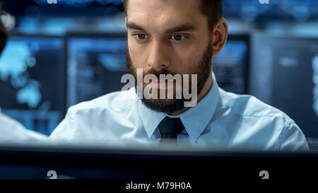 Neural Network and Machine Learning Engineer Working Hard at His Workstation. Multiple Displays Show Neural Network Representation. Stock Photo