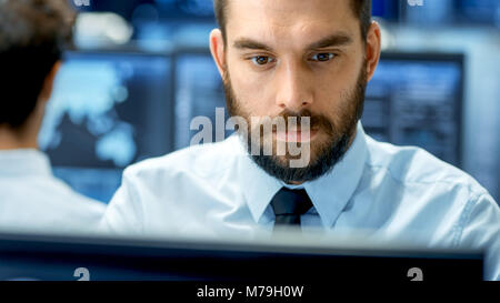 Neural Network and Machine Learning Engineer Working Hard at His Workstation. Multiple Displays Show Neural Network Representation. Stock Photo