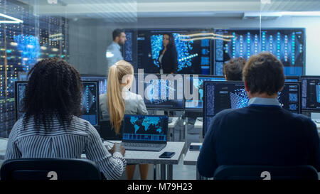 Multi-Ethnic Team of Research Engineers, Neural Network Architects, Programmists Working on a Machine Learning, Neural Network Building Project. Stock Photo