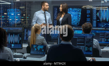 Head of the Department and Project Manager Discuss Work Process Using Data on Tablet Computer. Multi-Ethnic Team Builds Neural Network Stock Photo