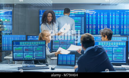 Multi-Ethnic Team of Traders is Busy Working at the Stock Exchange Office. Dealers and Brokers Buy and Sell Stocks on the Market. Stock Photo