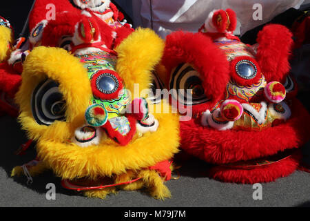 Close-up of two colorful, ornate dancing lion headdresses from the costumes worn in a Chinese Lunar New Years parade for Spring Festival. Stock Photo