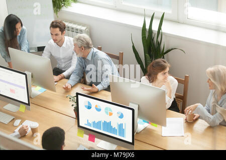 Senior executives teaching young employees in office, mentoring  Stock Photo