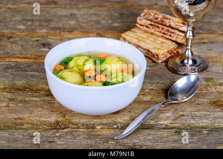 Delicious Matzoh ball soup with crackers wine and dill Passover Jewish holiday Food Stock Photo