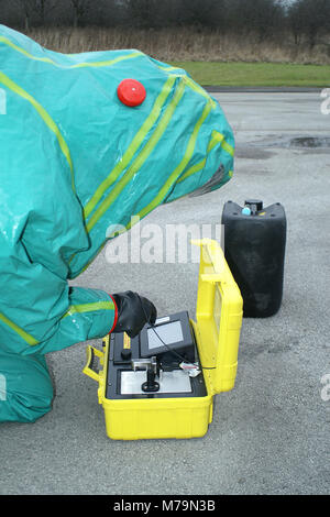 fire service Hazmat crew testing chemicals to identify Hazardous substance in emergency incident hot zone, chemical incident Stock Photo