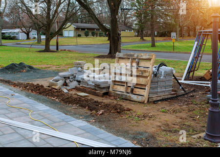 installation of a decorative stone on the sidewalk The lay out is a decorative stone pavement. Stock Photo
