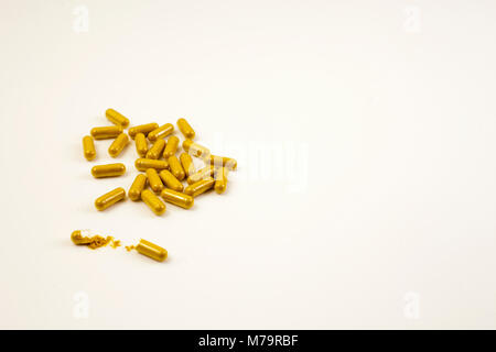 Several Turmeric capsules on with surface Stock Photo