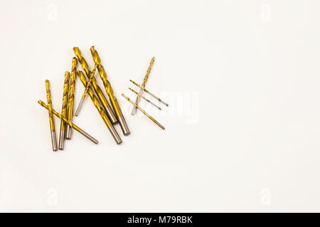 Several brass wood drill bits on white surface Stock Photo