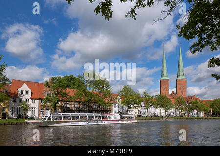 Tourist boat on the river Trave and the Lübeck Cathedral / Dom zu Lübeck / Lübecker Dom in the Hanseatic town Luebeck, Schleswig-Holstein, Germany Stock Photo