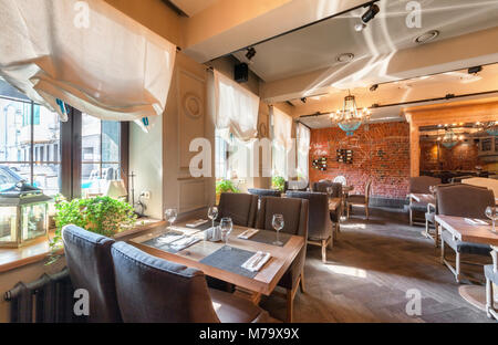 MOSCOW - AUGUST 2014: Interior elegant city restaurant 'RULET' in loft style. Tables near the windows Stock Photo