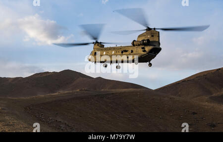 A U.S. Army Task Force Brawler CH-47F Chinook prepares to land during a personnel recovery exercise with a Guardian Angel team assigned to the 83rd Expeditionary Rescue Squadron at Bagram Airfield, Afghanistan, March 6, 2018. The Army crews and Air Force Guardian Angel teams conducted the exercise to build teamwork and procedures as they provide joint personnel recovery capability, aiding in the delivery of decisive airpower for U.S. Central Command. (U.S. Air Force Photo by Tech. Sgt. Gregory Brook) Stock Photo