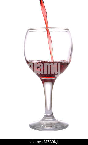Stream of red wine flows in a wineglass, isolated on white Stock Photo
