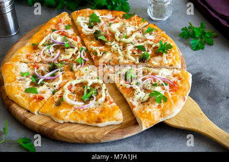 Vegetarian Pizza on rustic concrete background. Italian Pizza with Vegetables and Cheese close up. Stock Photo