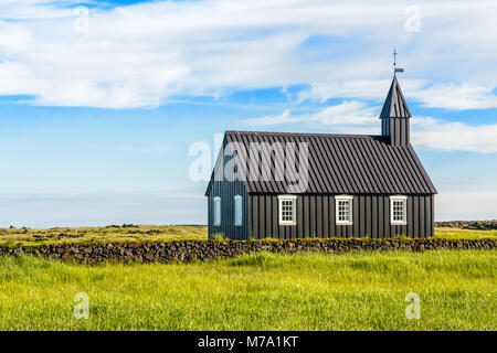 Budakirkja black painted lutheran church erected in 1847 with blue sky and clouds in the background, Snaefellsnes Peninsula, West Iceland Stock Photo