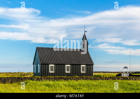 Budakirkja black painted lutheran church erected in 1847 with blue sky and clouds in the background, Snaefellsnes Peninsula, West Iceland Stock Photo