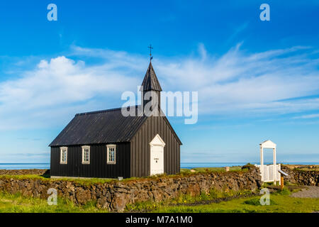 Budakirkja black painted lutheran parish erected in 1847 with blue sky and clouds in the background, Snaefellsnes Peninsula, West Iceland Stock Photo