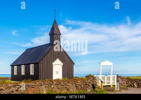 Budakirkja black painted lutheran parish erected in 1847 with blue sky and clouds in the background, Snaefellsnes Peninsula, West Iceland Stock Photo