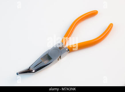 Bent long nose pliers on white background with orange handles Stock Photo