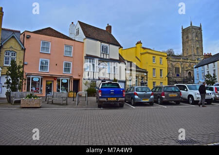 Colourful old buildings around the medieval square in the centre of Axbridge, Somerset. St John's Chruch in the background, dates from 1245. Stock Photo