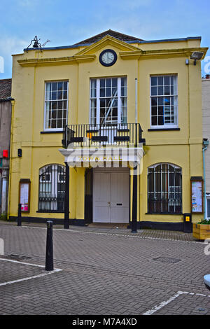 Axbridge Town Hall located in the medieval square in the centre of the Somerset town. It features a balcony and an unusual bell on the roof parapet. Stock Photo