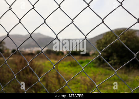 Wire mesh selective focus, blur landascape background Stock Photo