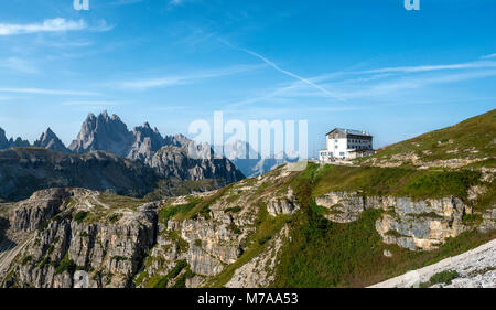 Auronzo alpine hut near the Three Peaks of Lavaredo, in the back Monte Campedelle and Col de le Bisse, Sexten Dolomites Stock Photo