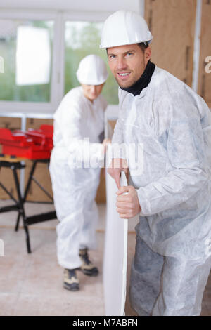 builder carrying the plywood Stock Photo