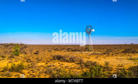 Steel Windpump in the semi desert Karoo region in South Africa Stock Photo