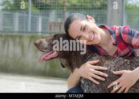 shelter keeper loves her residents Stock Photo