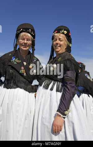 Women in traditional frisian costumes, in front of a windmill, Nebel ...