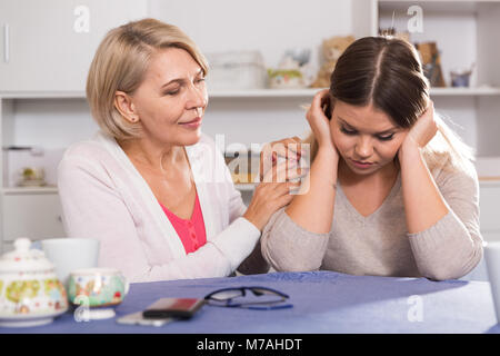 Kind mother comforts and supports her adult daughter after failure Stock Photo