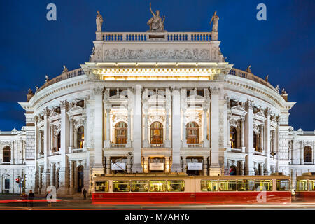 Blue hour at Burgtheater in Vienna with motion blur by tramway in the foreground Stock Photo