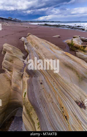 Spittal Beach, Berwick-upon-Tweed, Northumberland UK - red sandstone strata revealed by the tide. Stock Photo