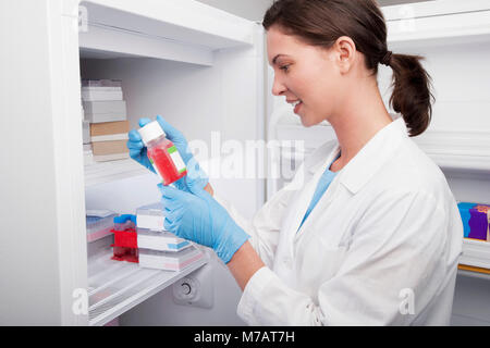 Female doctor holding a bottle of solution in a laboratory Stock Photo
