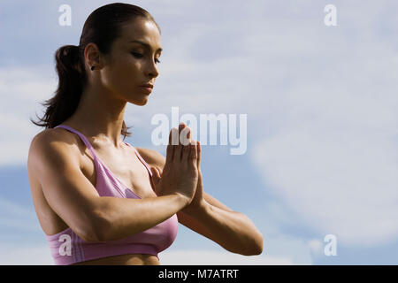 Side profile of a mid adult woman meditating Stock Photo