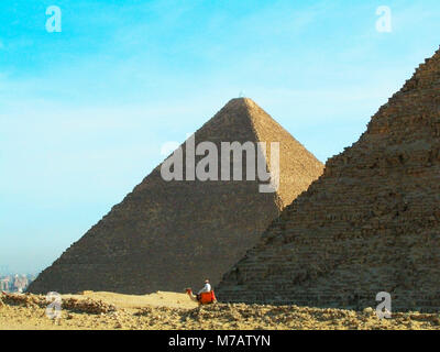 Man on a camel in front of the pyramids, Giza Pyramids, Giza, Cairo, Egypt Stock Photo
