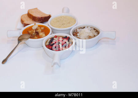High angle view of four assorted soups with breads Stock Photo